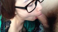 An Asian woman gives a blowjob in nerdy glasses