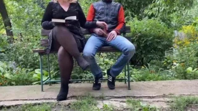 Curvy step mother jerks off her step son in the park while reading a book
